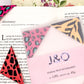 An open book with a selection of animal print origami bookmarks