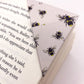 Origami insect bookmark on the corner of a book