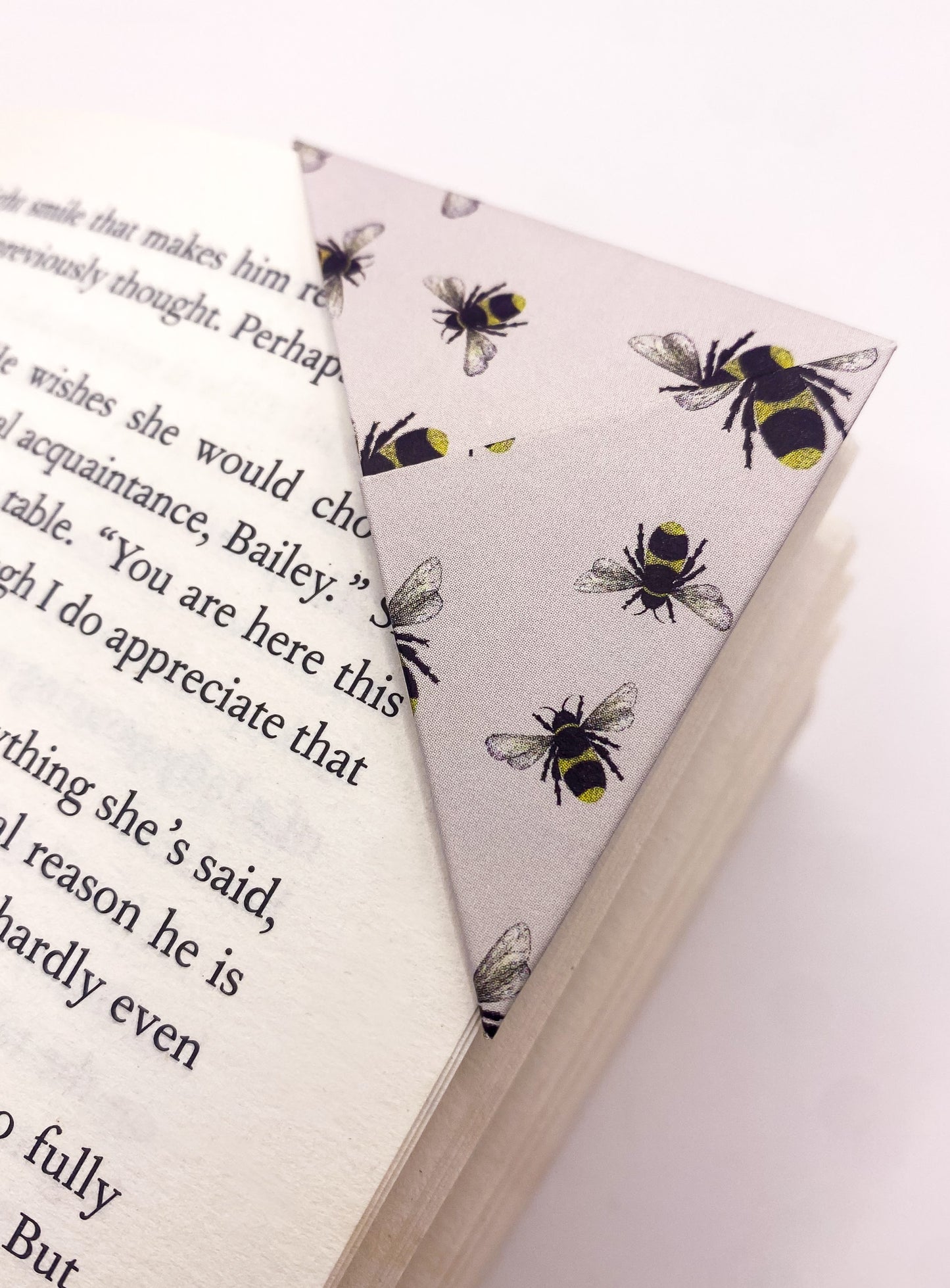 Origami insect bookmark on the corner of a book