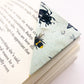 Origami insect bookmark on the corner of a book