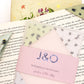 A book with an origami insect bookmark on the corner with a set of bookmarks 