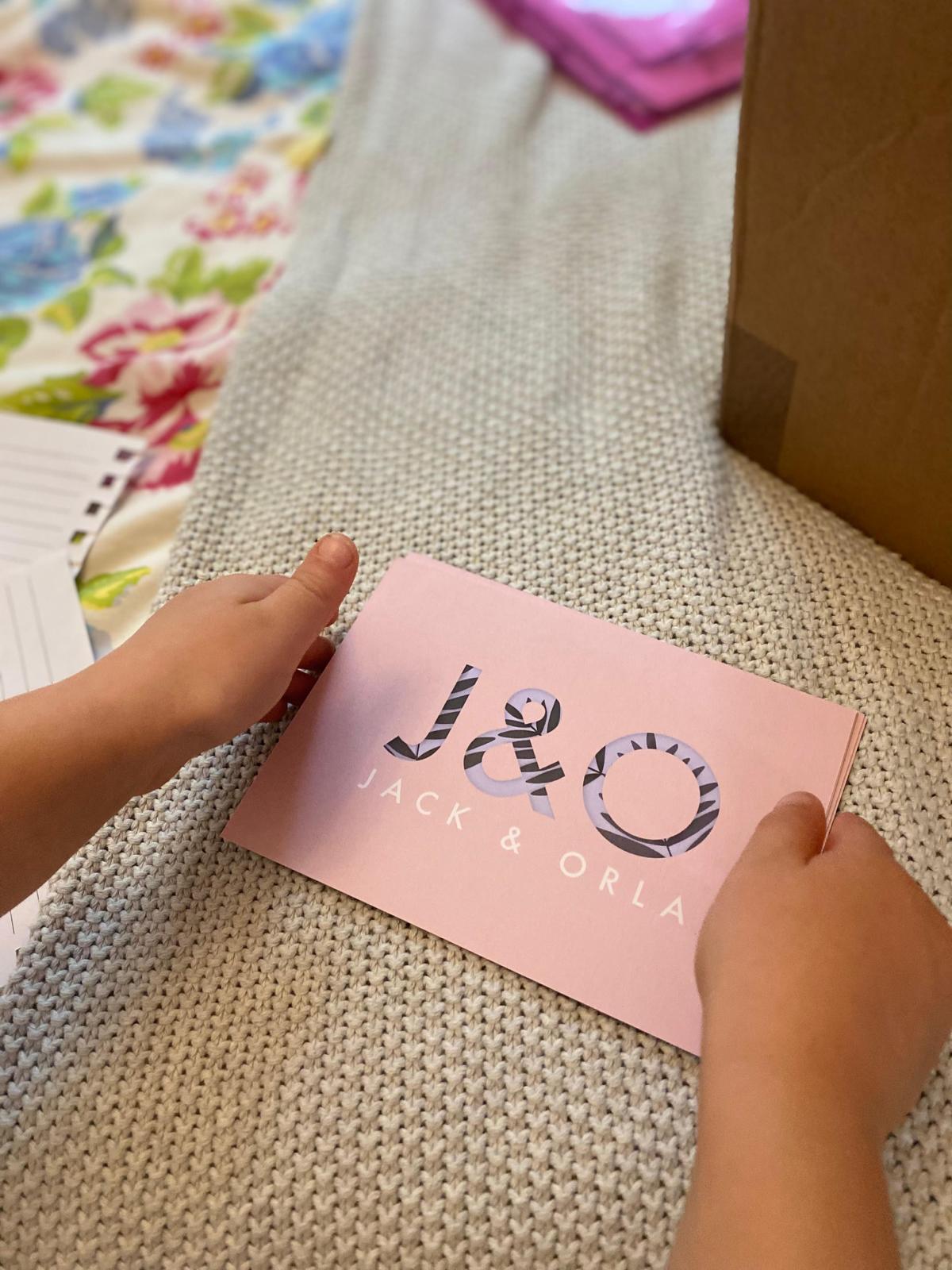 Orla playing with Jack & Orla packaging