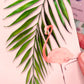 Close-up of pastel tropics postcard featuring flamingo and palm leaf by Jack & Orla