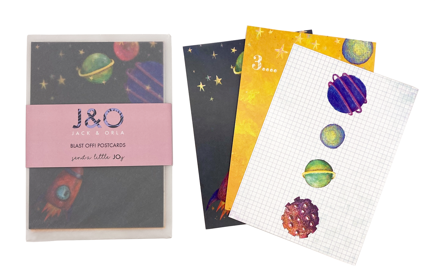 A photo featuring three of the designs in the space themed postcard gift set, as well as a packaged set. The front postcard features a square grid background with four brightly coloured planets.